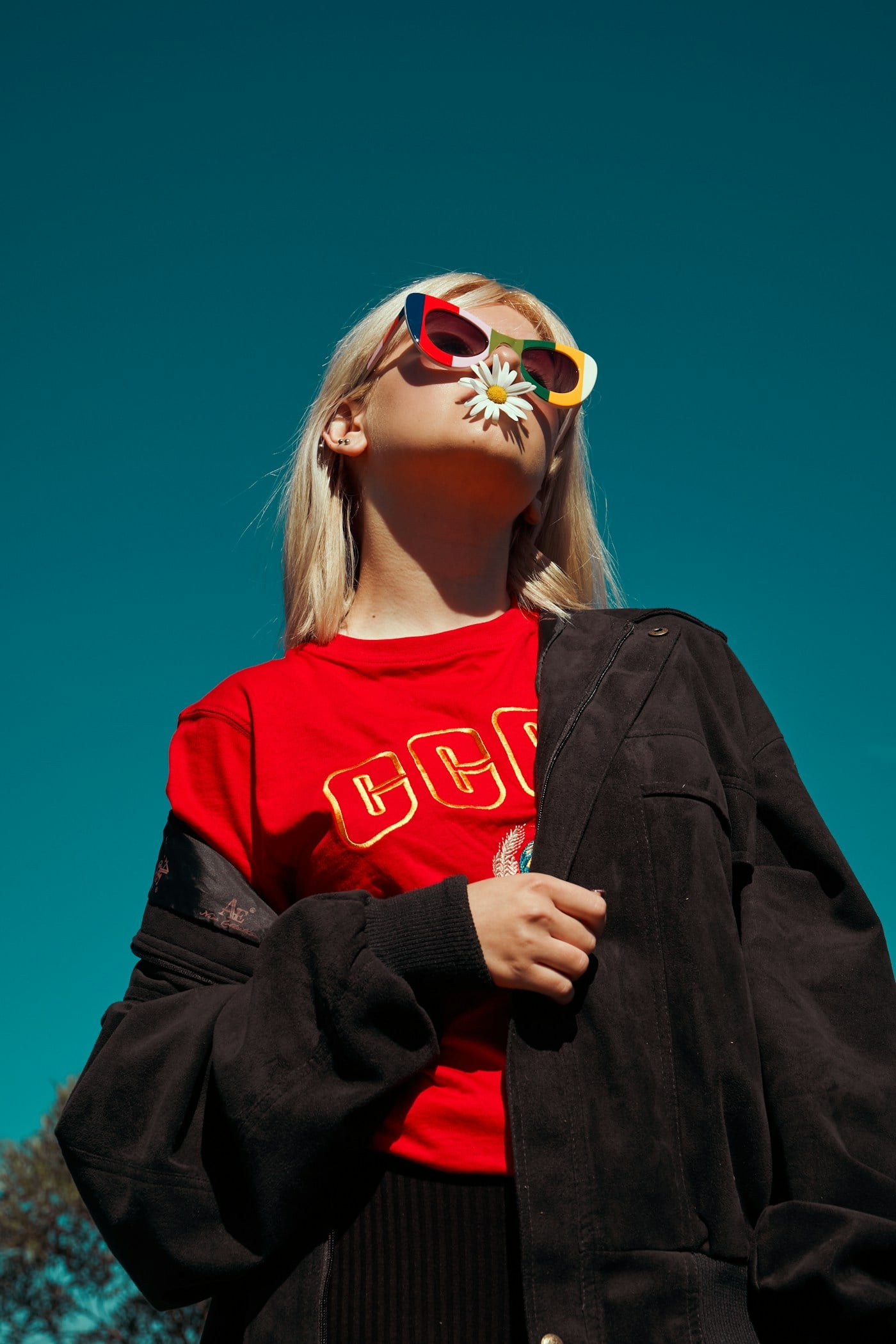 Woman wearing colorful sunglasses in a fashion editorial scene