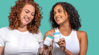 Two women holding Happy V wellness products