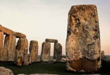 Stonehenge stones at dusk in an open landscape
