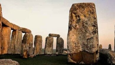 Stonehenge stones at dusk in an open landscape
