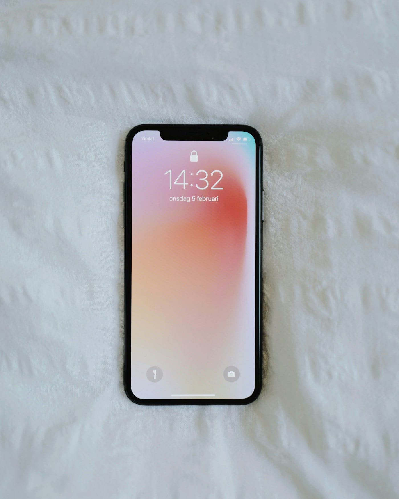 Smartphone resting on a bed