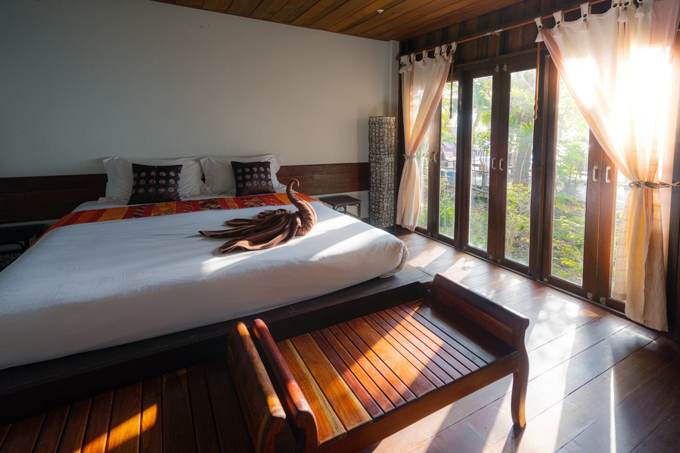 Sunlit hotel bedroom prepared for a trip