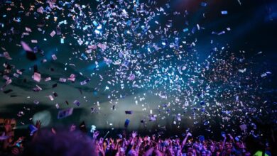 Outdoor travel event scene with a crowd and stage