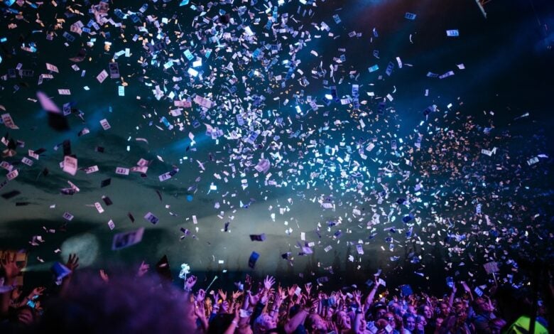 Outdoor travel event scene with a crowd and stage