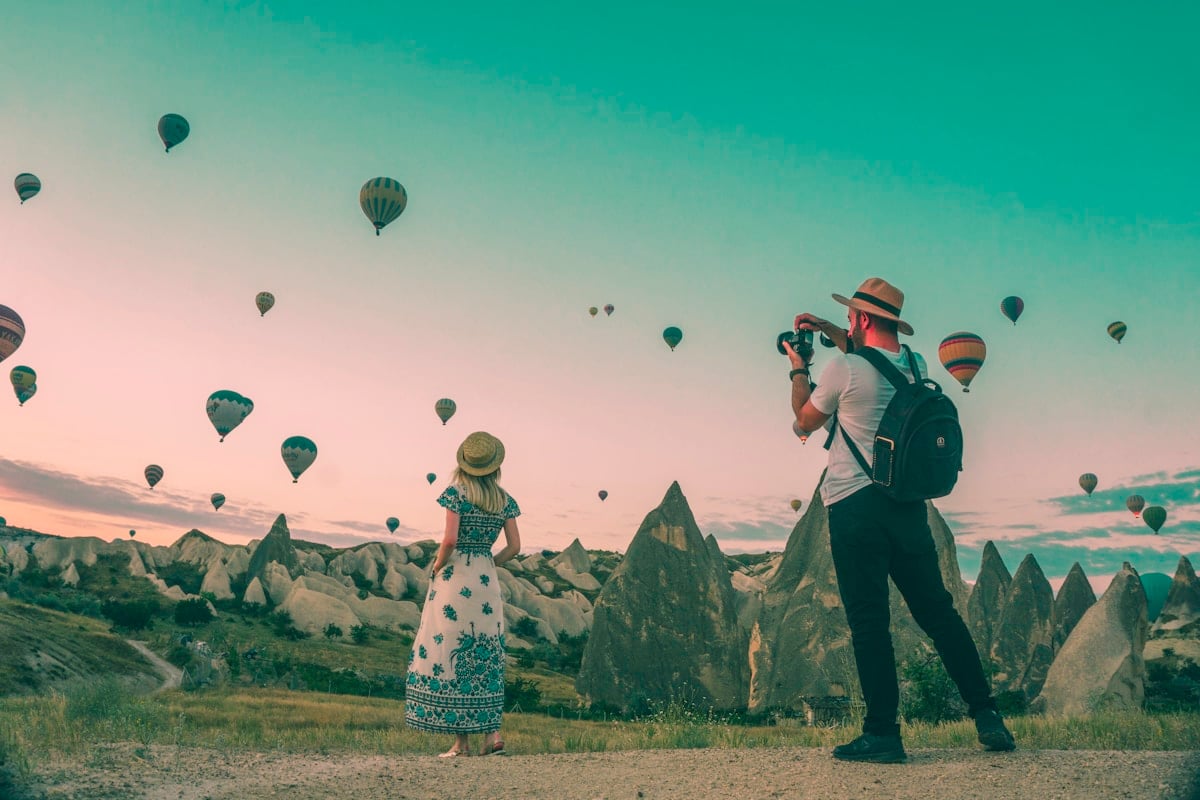 Travelers watching hot air balloons
