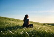Woman sitting in a meadow in a Bolt Pharmacy care scene