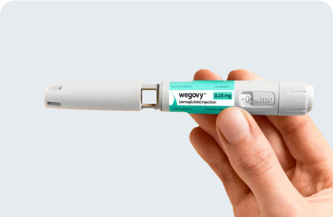 A hand holds a Wegovy FlexTouch injection pen against a blue background