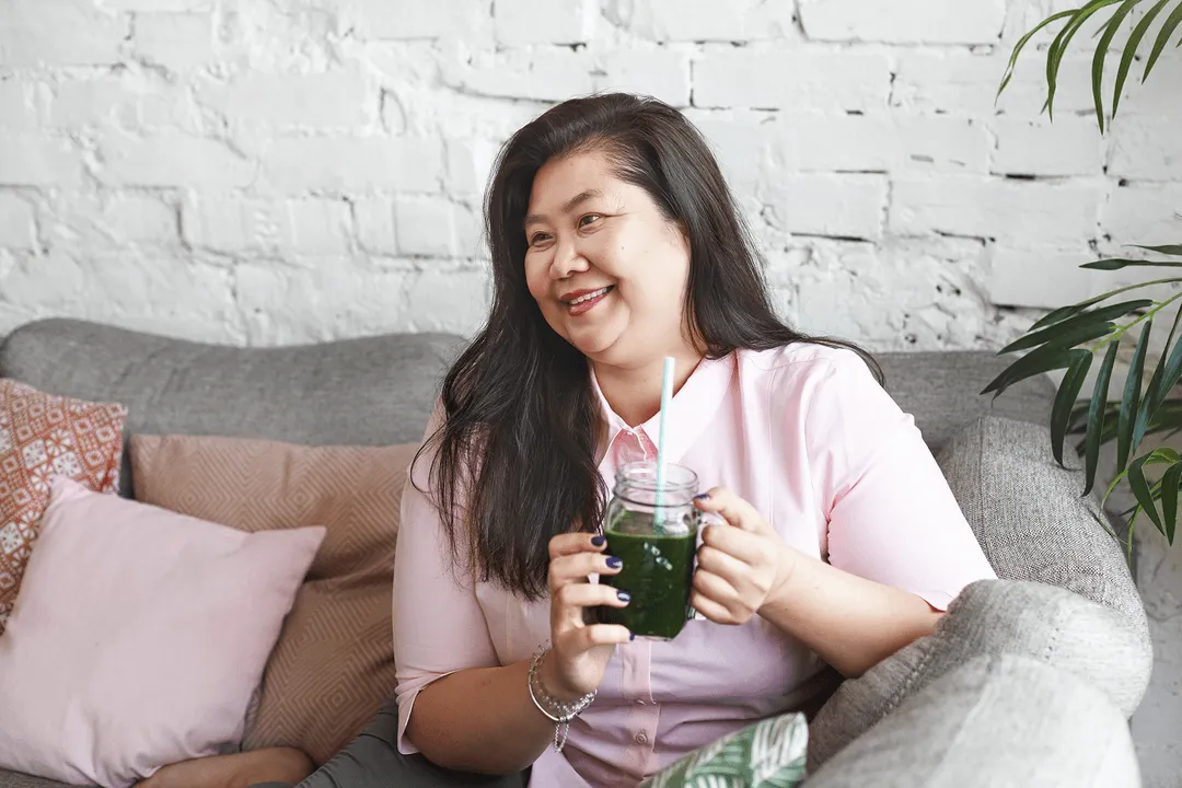 A woman sits on a couch in a room
