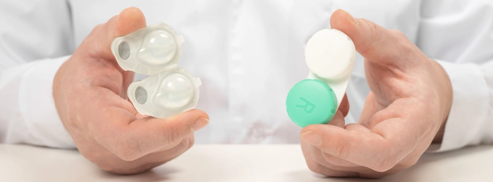 Hands holding contact lenses