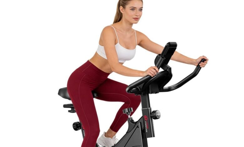 Woman riding a Home Fitness Code indoor exercise bike
