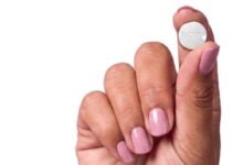 A hand holding a tablet for PillSorted’s Wegovy pill service