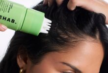 Model applying REHAB Matcha Scalp Serum