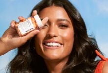 REHAB Sunshine Spritz hair oil in a styled product scene