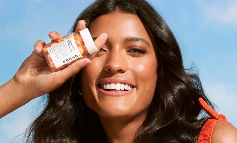REHAB Sunshine Spritz hair oil in a styled product scene