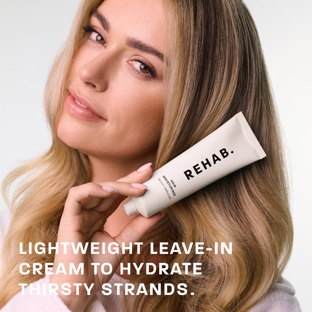 Model holding REHAB Hair Milk moisturiser