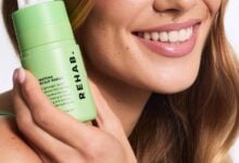 Model applying REHAB Matcha Scalp Serum