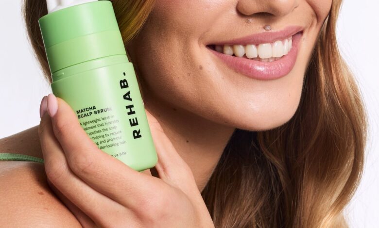 Model applying REHAB Matcha Scalp Serum